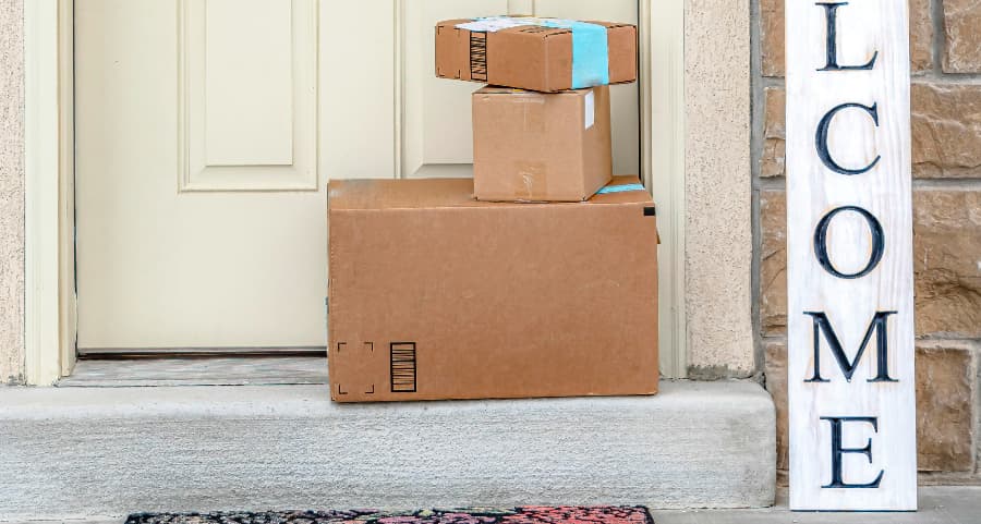 Boxes by the door of a residence with a welcome sign in Oakland